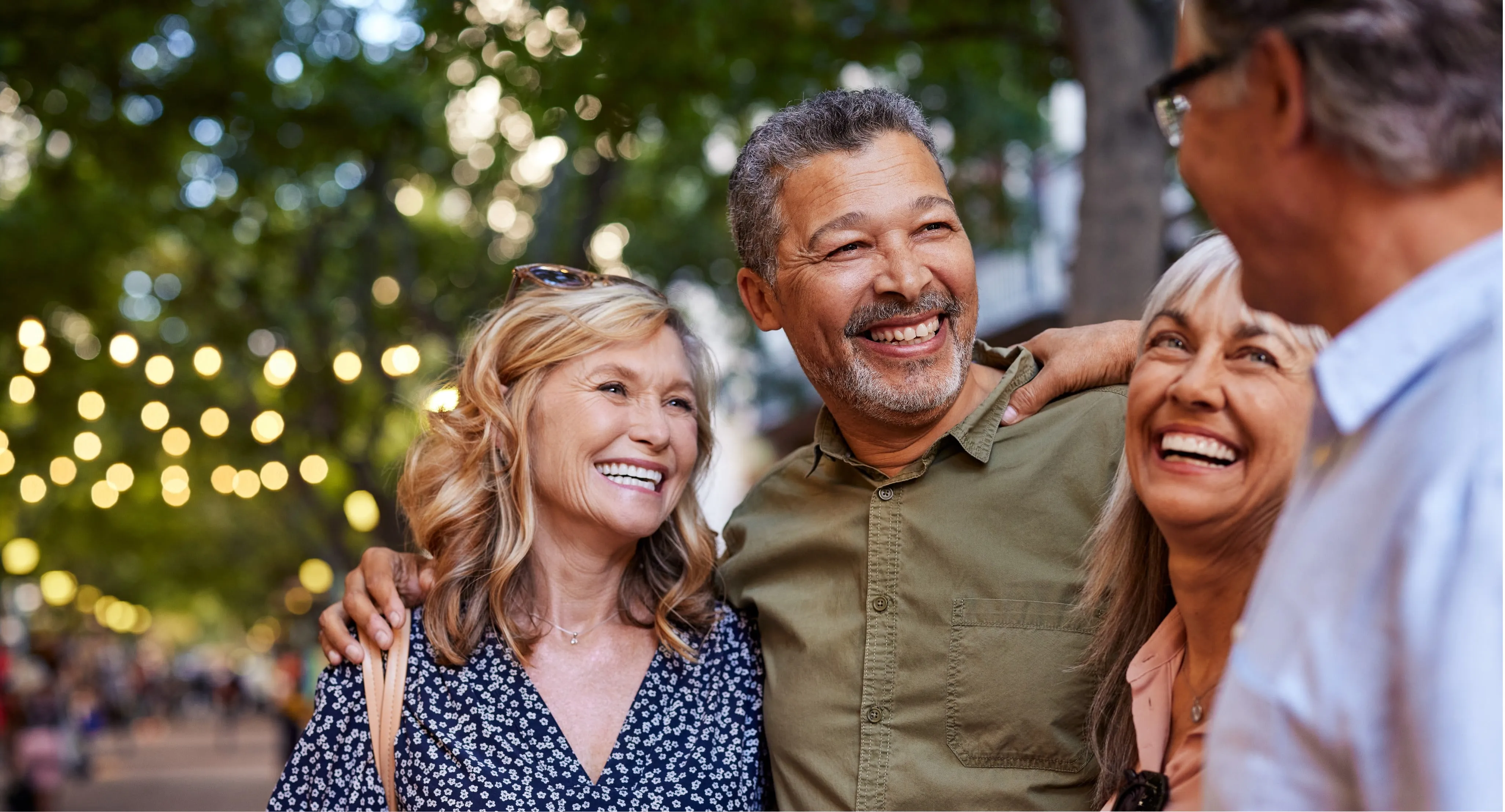 a group of people outside laughing and visiting with each other.