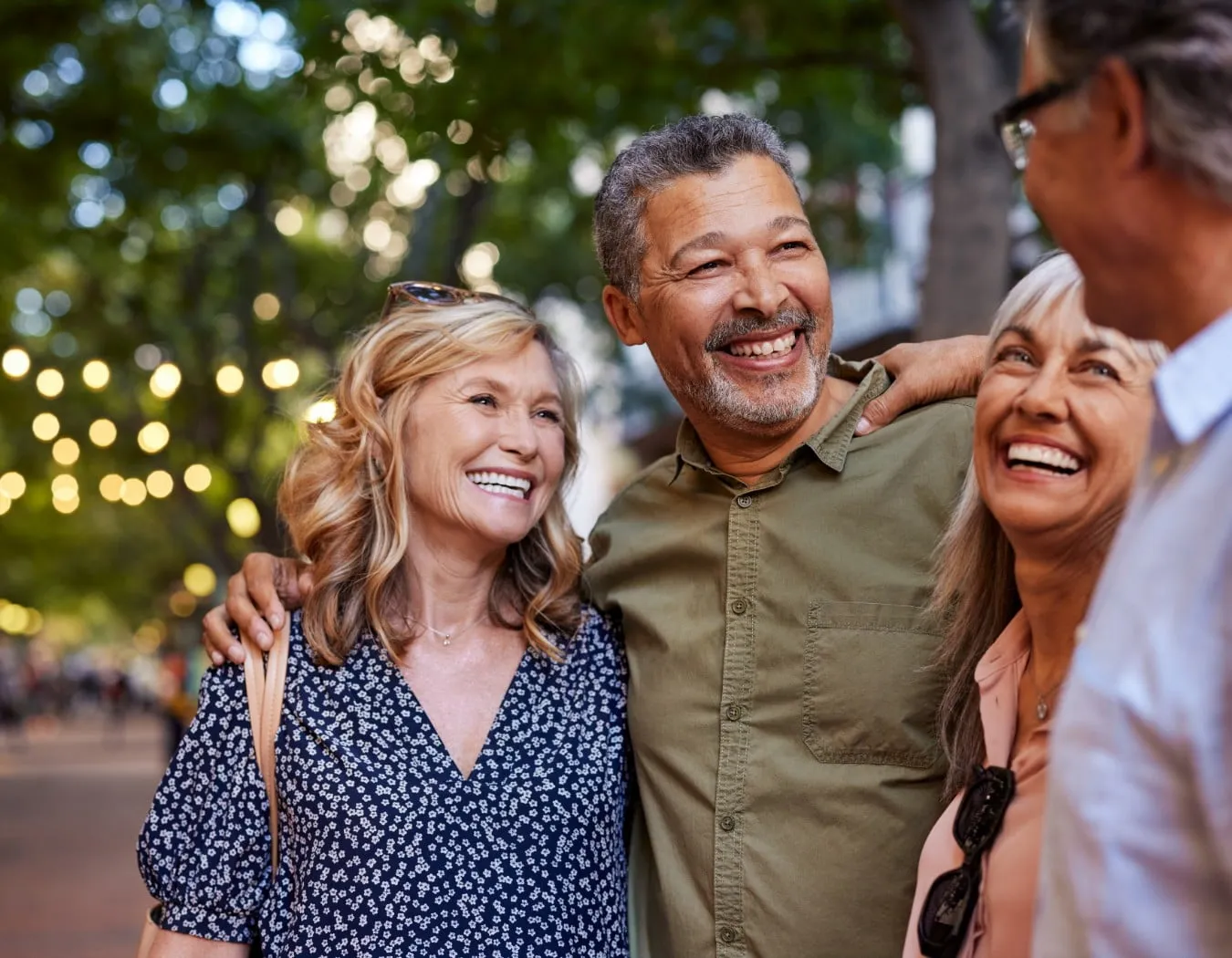 a group of people outside laughing and visiting with each other.