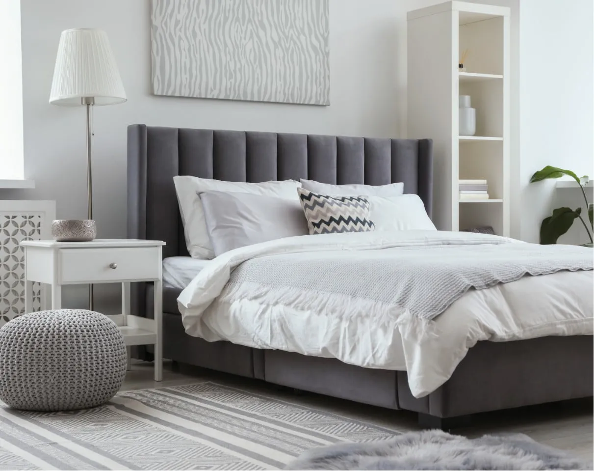 a bedroom with a bed all made up